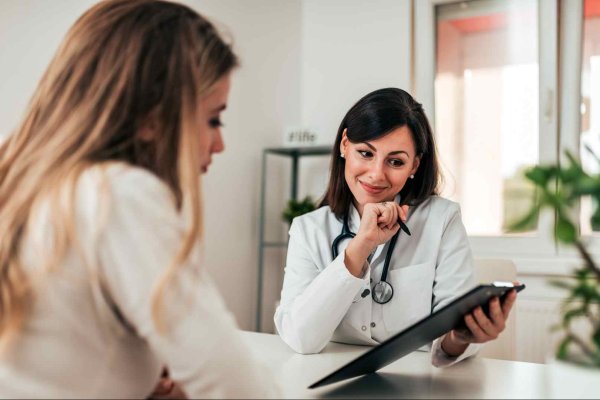 Hair loss doctor trichologist treating woman